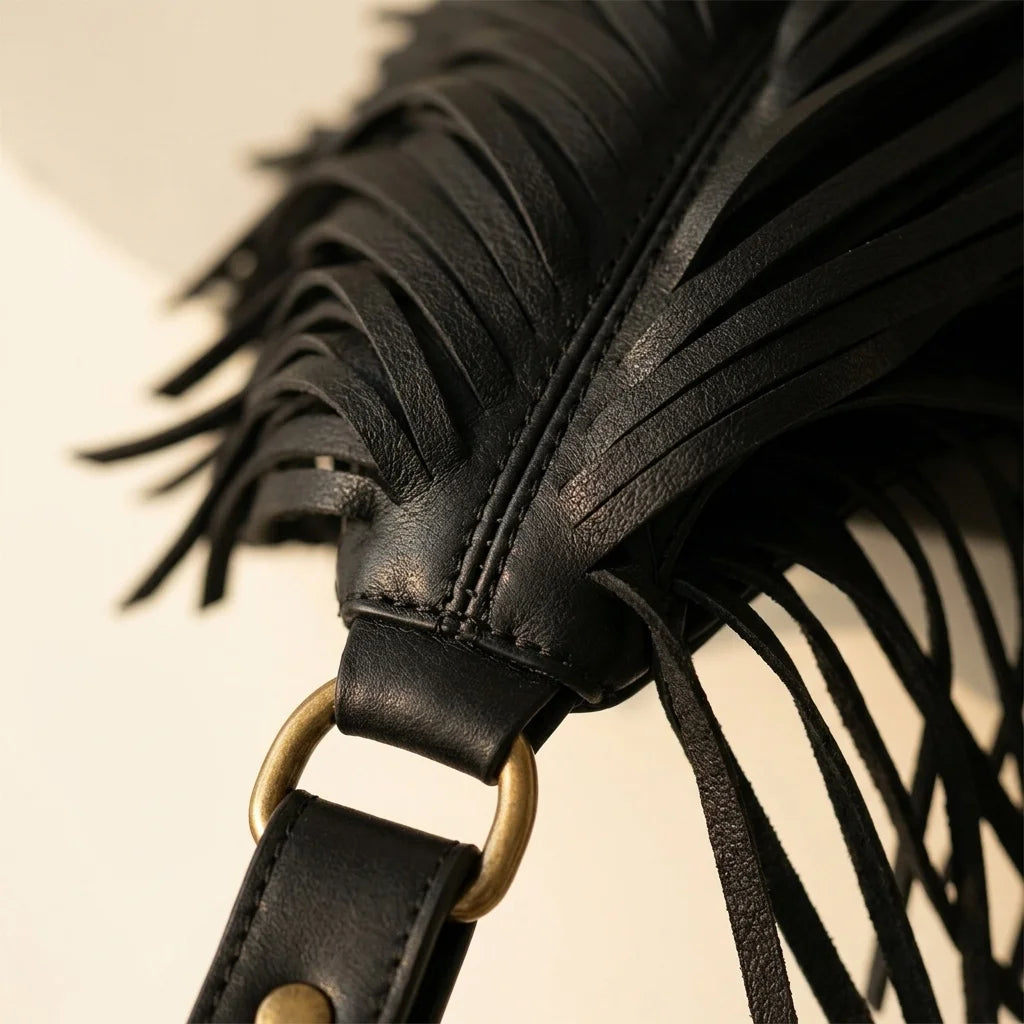 Close-up of fringe stitching and texture on Black genuine leather fringe hobo bag