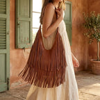 Woman wearing Brown genuine leather fringe hobo bag with swaying fringe