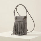 Grey gray crossbody bag fringe, three-quarter angle showing side depth