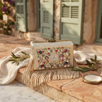 Gold large fringe clutch bag styled in a warm Mediterranean setting