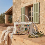 White large fringe clutch bag styled in a warm Mediterranean setting