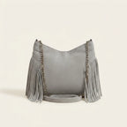 Back panel of Grey large fringe crossbody bag with strap attachments