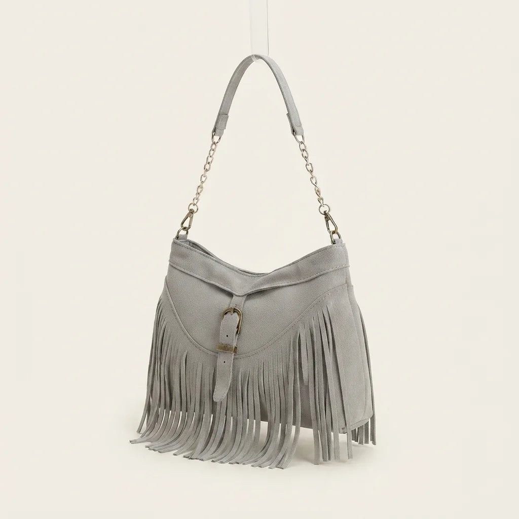 Grey large fringe crossbody bag, three-quarter angle showing side depth