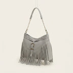 Grey large fringe crossbody bag, three-quarter angle showing side depth