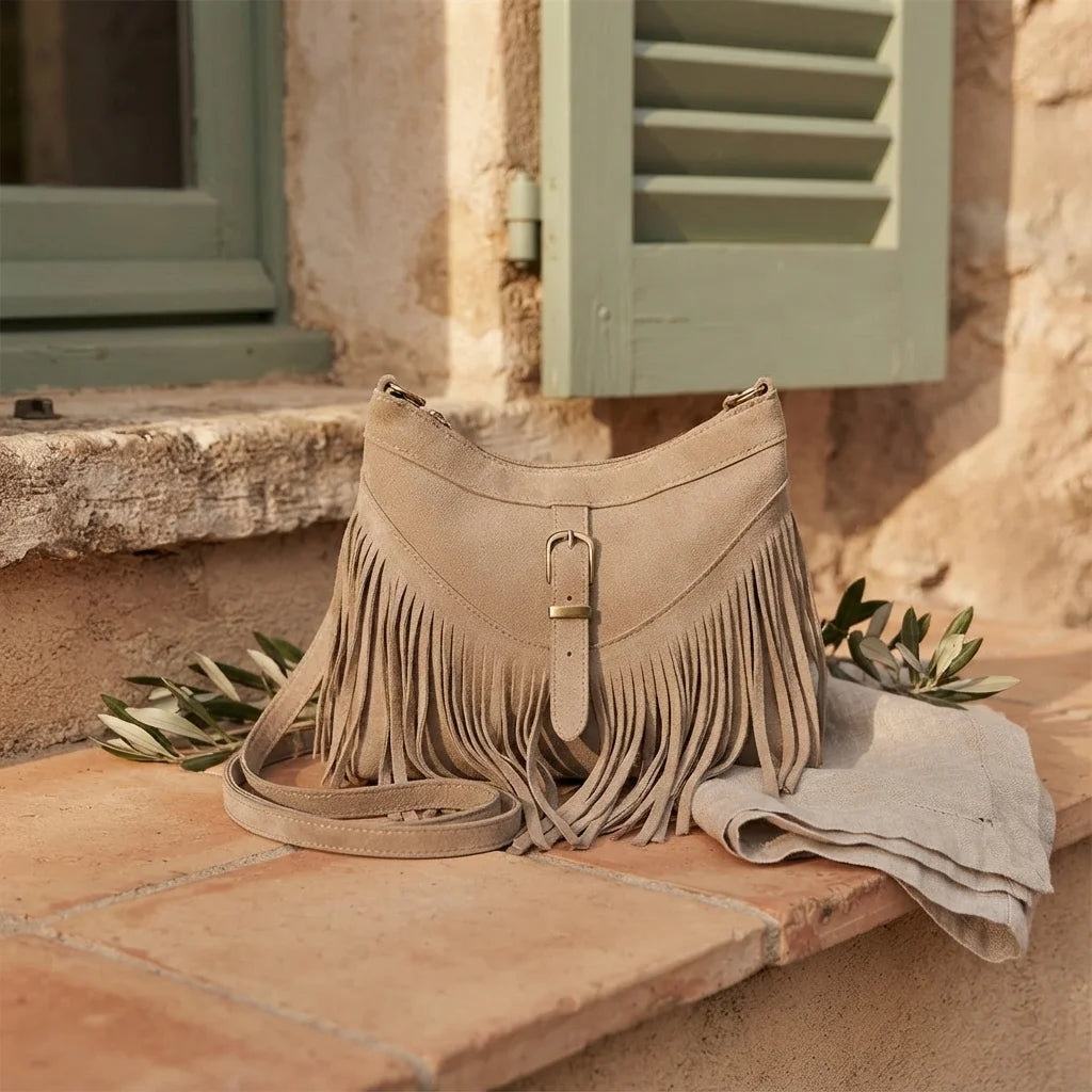 Light Brown large fringe crossbody bag styled in a warm Mediterranean setting
