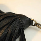 Close-up of fringe stitching and texture on Black large fringe faux leather hobo bag