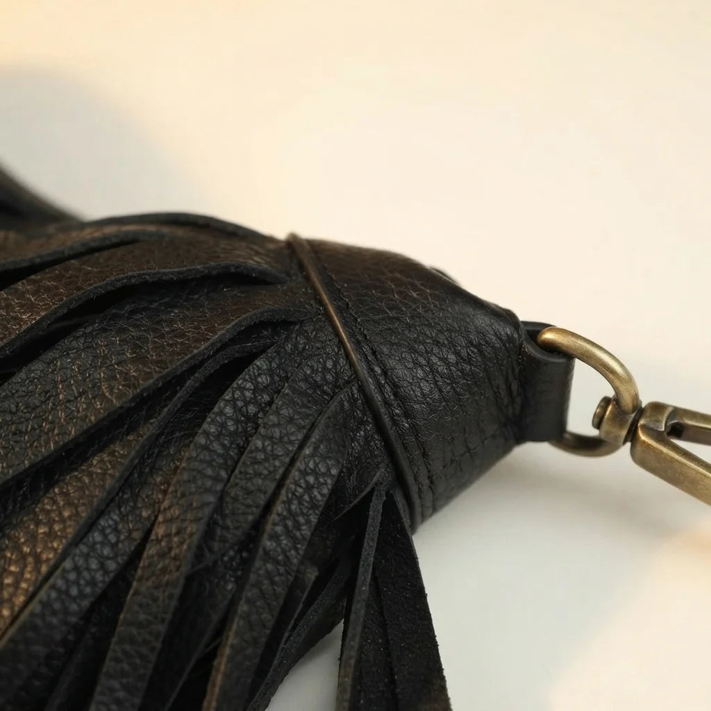 Close-up of fringe stitching and texture on Black large fringe faux leather hobo bag