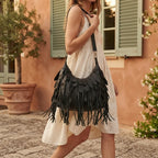 Woman wearing Black large fringe faux leather hobo bag with swaying fringe