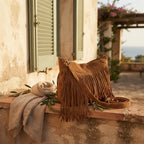 Brown large fringe hobo bag styled in a warm Mediterranean setting