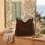Coffee large fringe hobo bag styled in a warm Mediterranean setting
