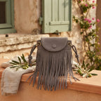 Grey large fringe shoulder bags styled in a warm Mediterranean setting