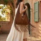 Woman wearing Coffee large hippie fringe bag with swaying fringe
