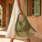 Woman wearing Green large hippie fringe bag with swaying fringe