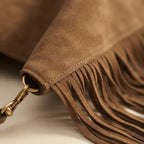 Close-up of fringe stitching and texture on Coffee large suede fringe bag