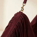 Close-up of fringe stitching and texture on Maroon large suede fringe bag