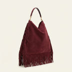 Maroon large suede fringe bag, three-quarter angle showing side depth