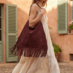 Woman wearing Maroon large suede fringe bag with swaying fringe