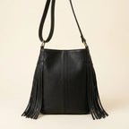 Back panel of Black leather bucket bag with fringes with strap attachments