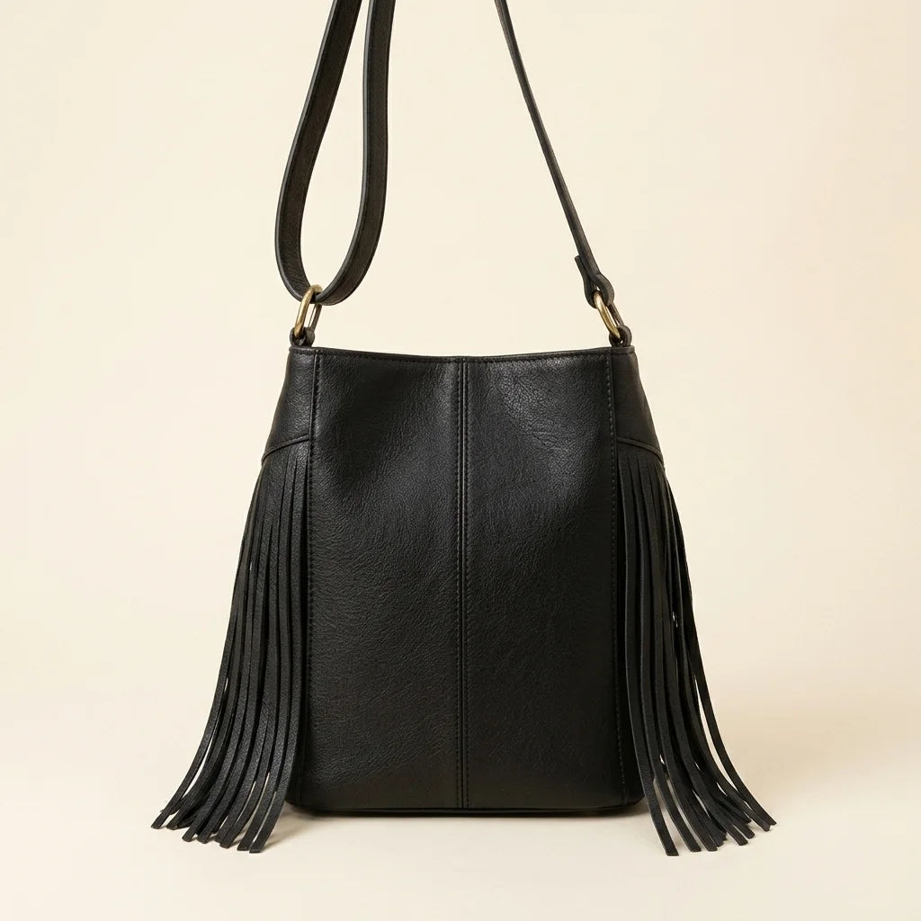 Back panel of Black leather bucket bag with fringes with strap attachments