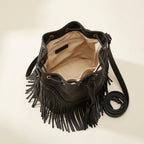 Interior lining and pockets of Black leather bucket bag with fringes