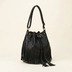 Black leather bucket bag with fringes, three-quarter angle showing side depth
