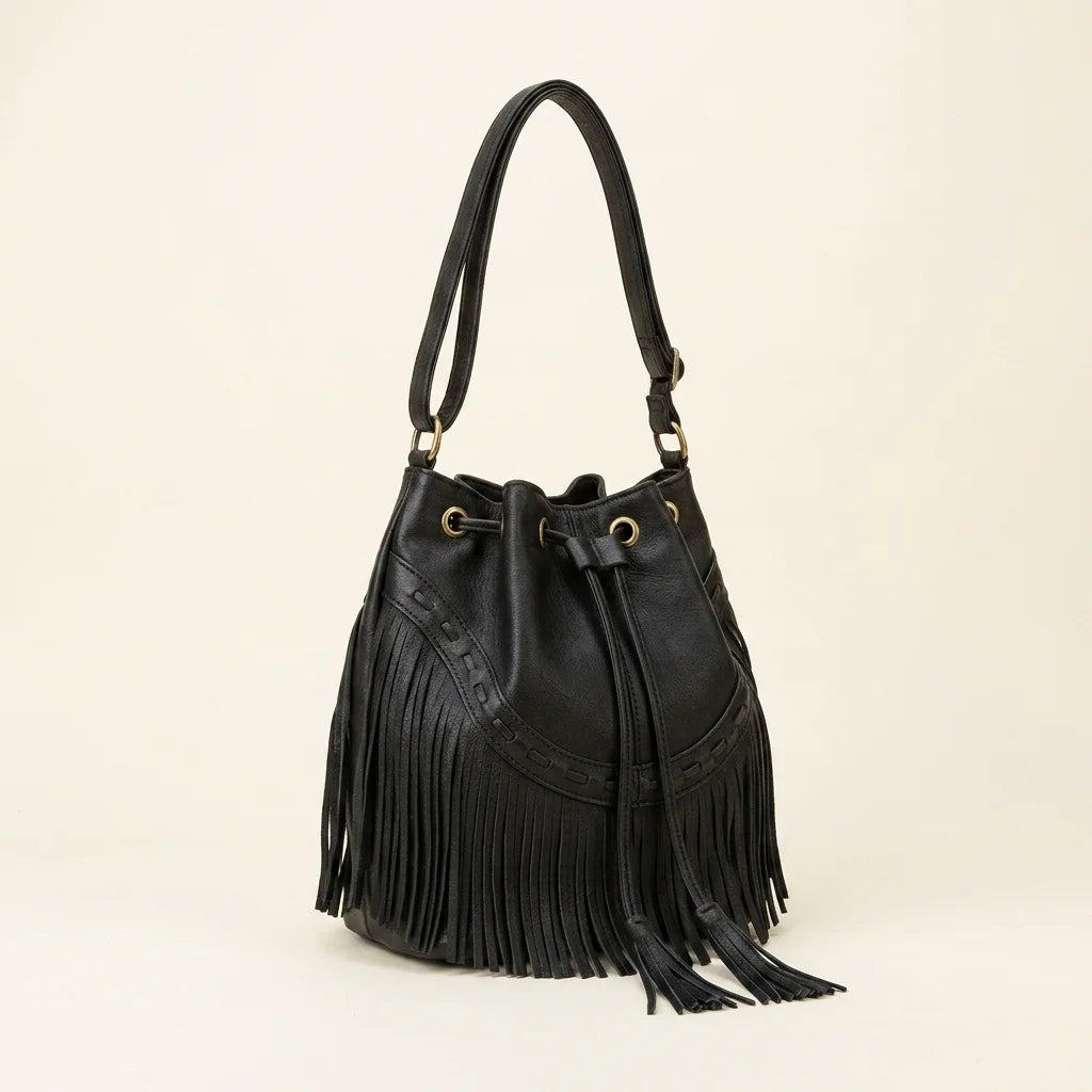 Black leather bucket bag with fringes, three-quarter angle showing side depth