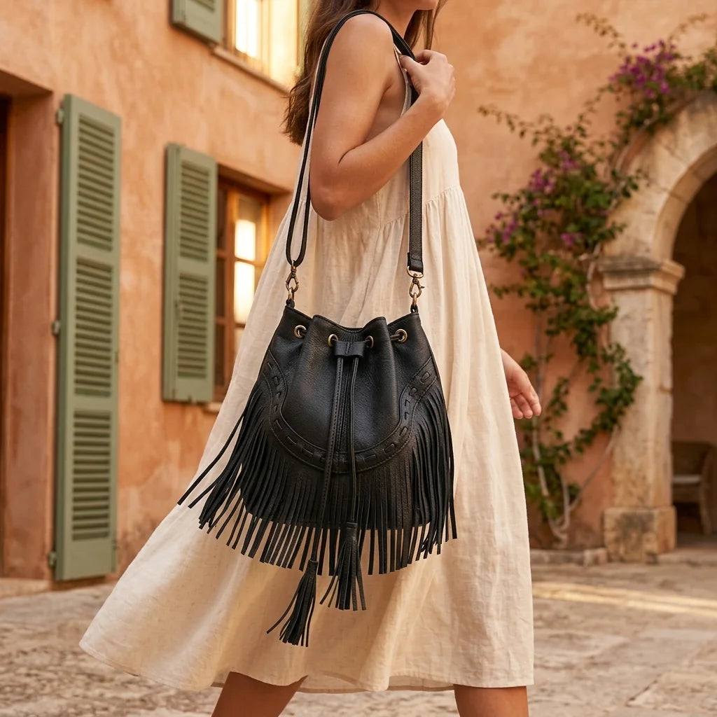 Woman wearing Black leather bucket bag with fringes with swaying fringe