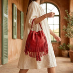 Woman wearing Red leather bucket bag with fringes with swaying fringe
