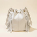 Back panel of White leather bucket bag with fringes with strap attachments
