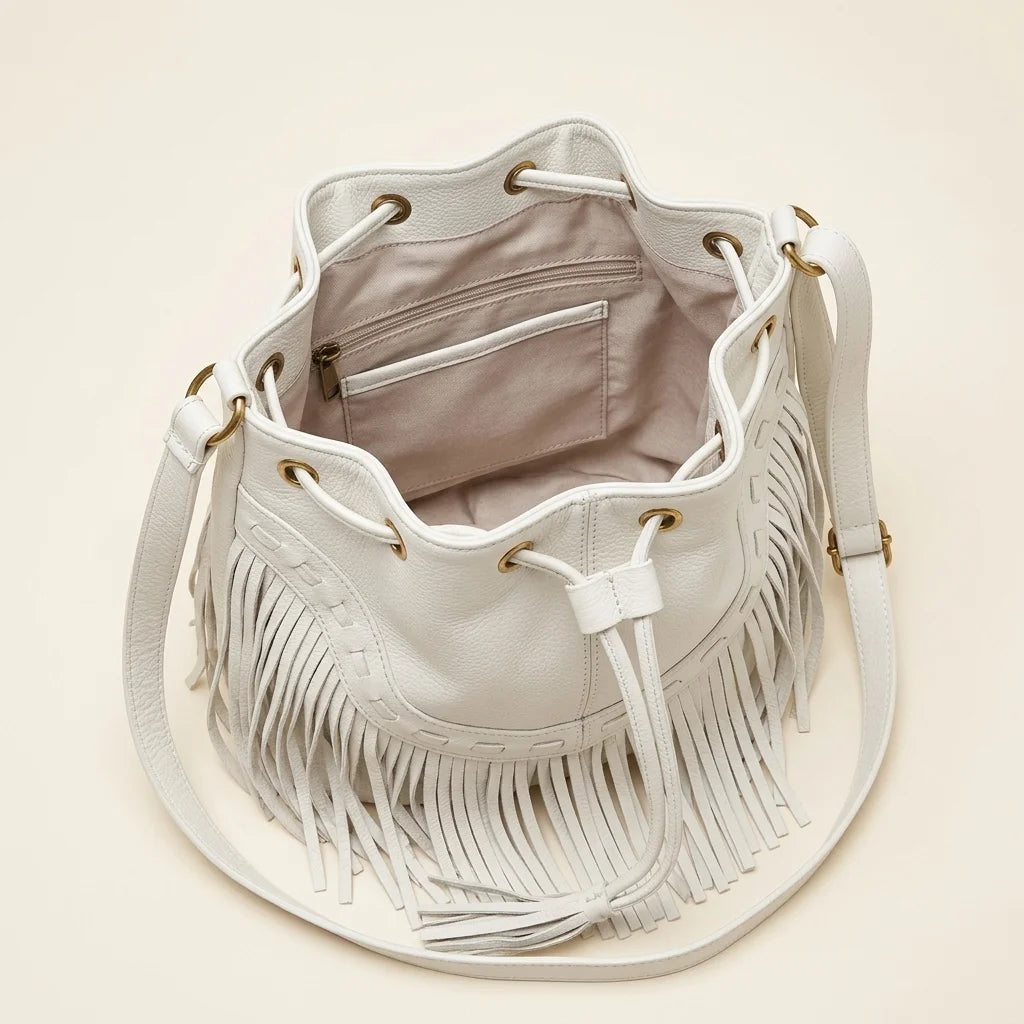 Interior lining and pockets of White leather bucket bag with fringes