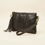 Black leather clutch bags with side fringe, three-quarter angle showing side depth