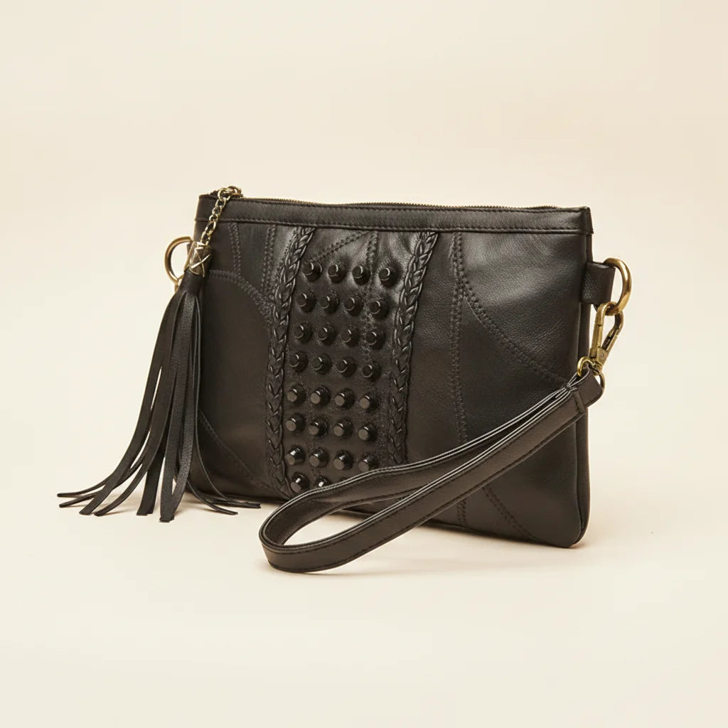 Black leather clutch bags with side fringe, three-quarter angle showing side depth