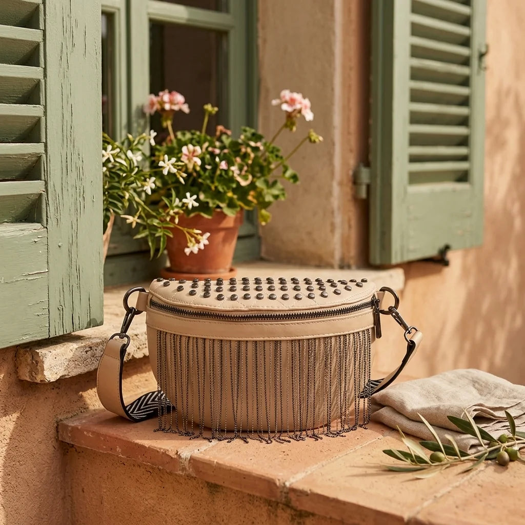 Beige leather fringe belt bag styled in a warm Mediterranean setting