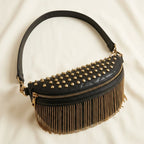 Black leather fringe belt bag, three-quarter angle showing side depth