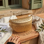 Gold leather fringe belt bag styled in a warm Mediterranean setting