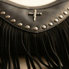 Close-up of fringe stitching and texture on Black leather fringe messenger bag