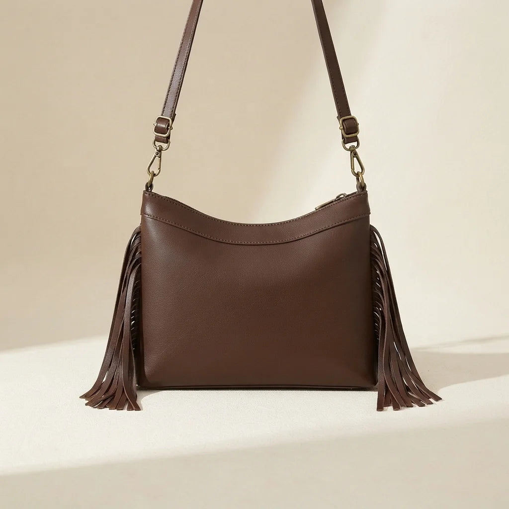 Back panel of Brown leather fringe messenger bag with strap attachments
