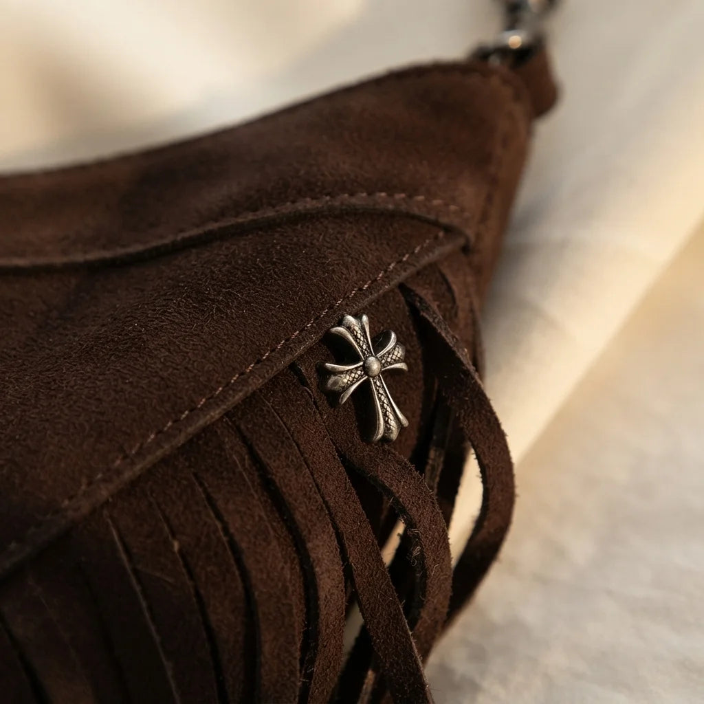 Close-up of fringe stitching and texture on Brown leather fringe messenger bag