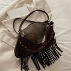 Interior lining and pockets of Brown leather fringe messenger bag