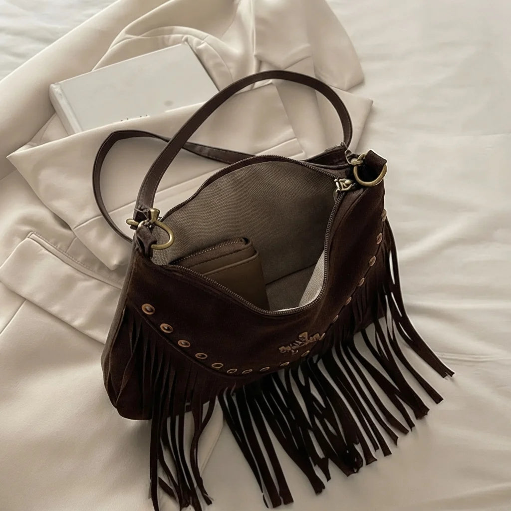 Interior lining and pockets of Brown leather fringe messenger bag