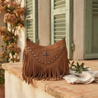 Coffee leather fringe messenger bag styled in a warm Mediterranean setting