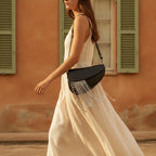 Woman wearing Black leather saddle bag fringe with swaying fringe