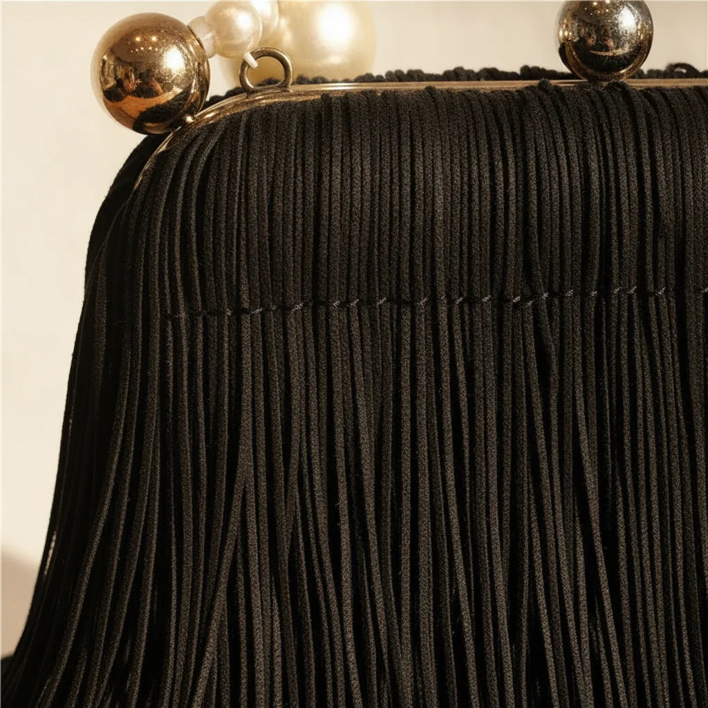Close-up of fringe stitching and texture on Black long fringe clutch bag