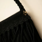 Close-up of fringe stitching and texture on Black macrame fringe bag