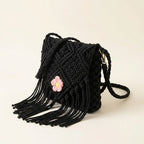 Black macrame fringe bag, three-quarter angle showing side depth