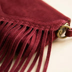 Close-up of fringe stitching and texture on Burgundy mini fringe crossbody bag