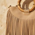 Close-up of fringe stitching and texture on Beige mini fringe shoulder bag