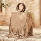 Beige mini fringe shoulder bag, three-quarter angle showing side depth