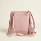 Back panel of Pink mini fringe shoulder bag with strap attachments