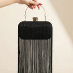 Back panel of black fringe evening bag with strap attachments